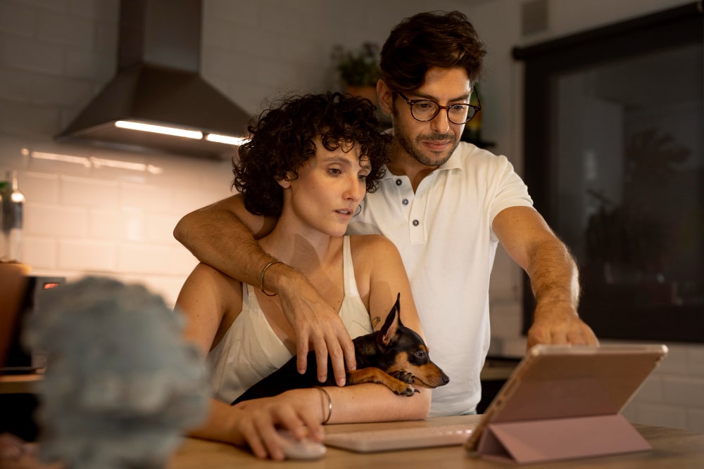 Lachende mensen in een slim huis met laptop